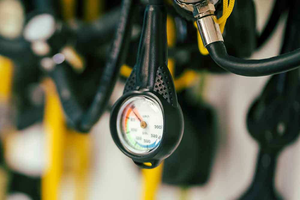 62329960_a-diving-equipment-with-regulators-and-tools-for-checking-barrels